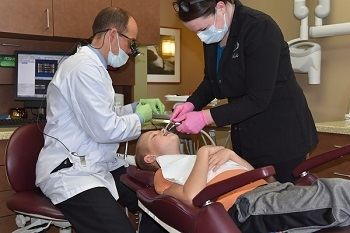 A teeth cleaning for your kids will keep their mouth healthy Madison Dentists Performing Teeth Cleaning on Child